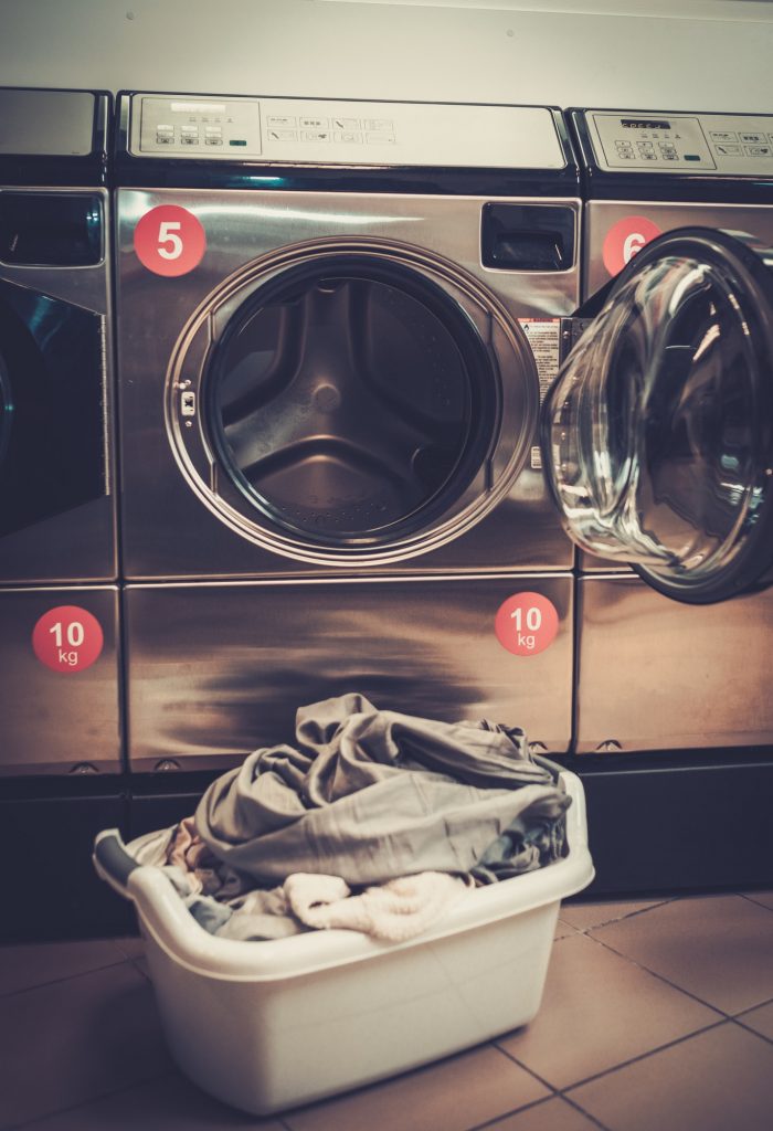 Laundry machines at laundromat shop.